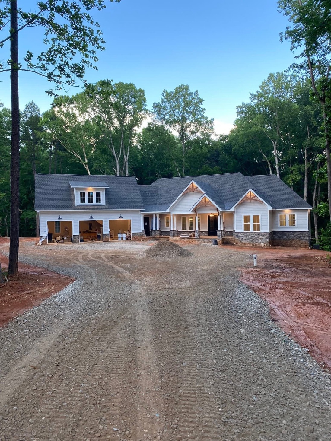 Completed new home with graded driveway and gravel